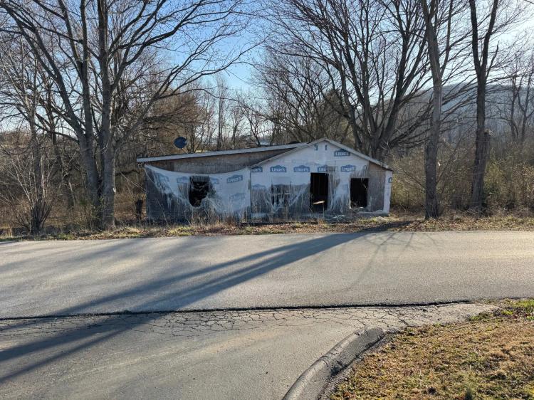 Unfinished remodel with detached garage on Lot in town