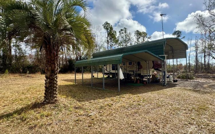 1.5 Acres of Land in Jasper, FL for Sale - Metal RV Shelter!