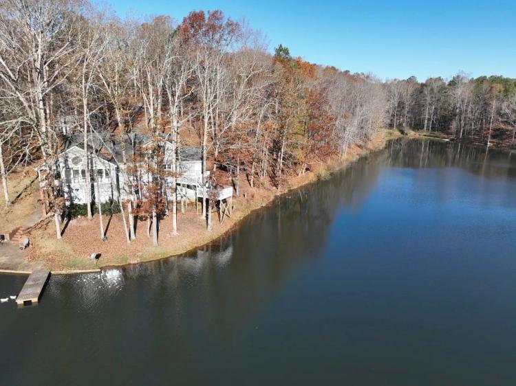 155 Acres with house and stunning wrap around lake in Roopville, GA